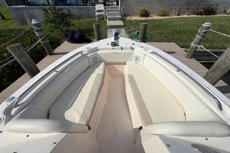 Slide: The Image of 2011 Grady-White Freedom 255 boat with spacious seating and sleek design at dock. - 11