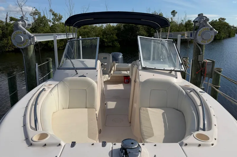 Slide: The Image of 2011 Grady-White Freedom 255 boat docked, featuring spacious seating and open deck. - 12