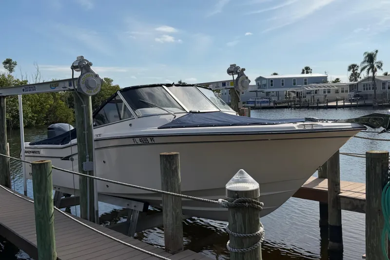 Slide: The Image of 2011 Grady-White Freedom 255 boat docked at a marina, sunny day. - 14
