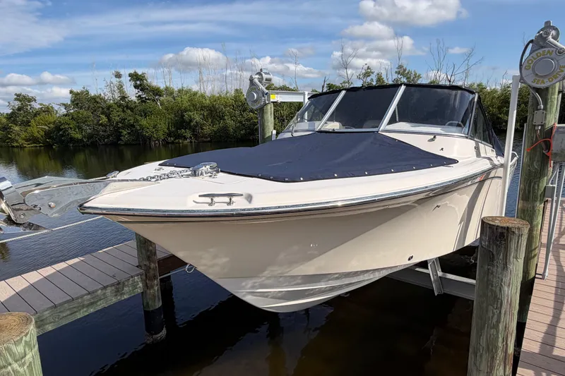 Slide: The Image of 2011 Grady-White Freedom 255 boat docked by a serene waterway. - 16