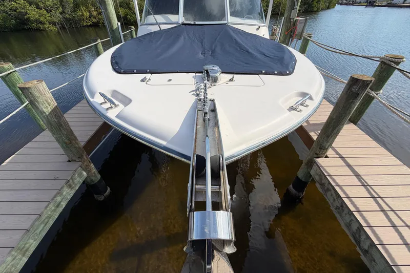 Slide: The Image of 2011 Grady-White Freedom 255 boat docked, covered bow, calm water setting. - 17