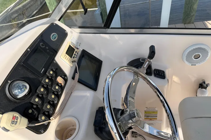 Slide: The Image of 2011 Grady-White Freedom 255 boat dashboard with steering wheel and control panel. - 4