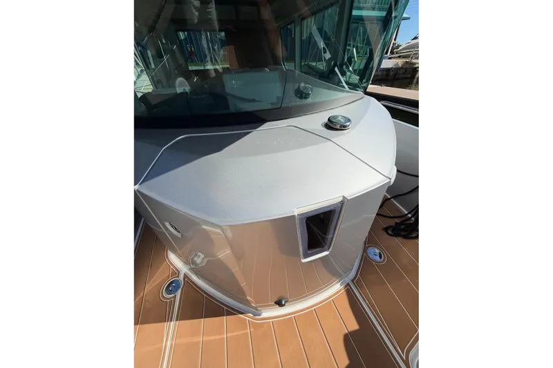 Slide: The Image of 2019 Axopar 28 Cabin boat with sleek design and wooden deck details. - 18