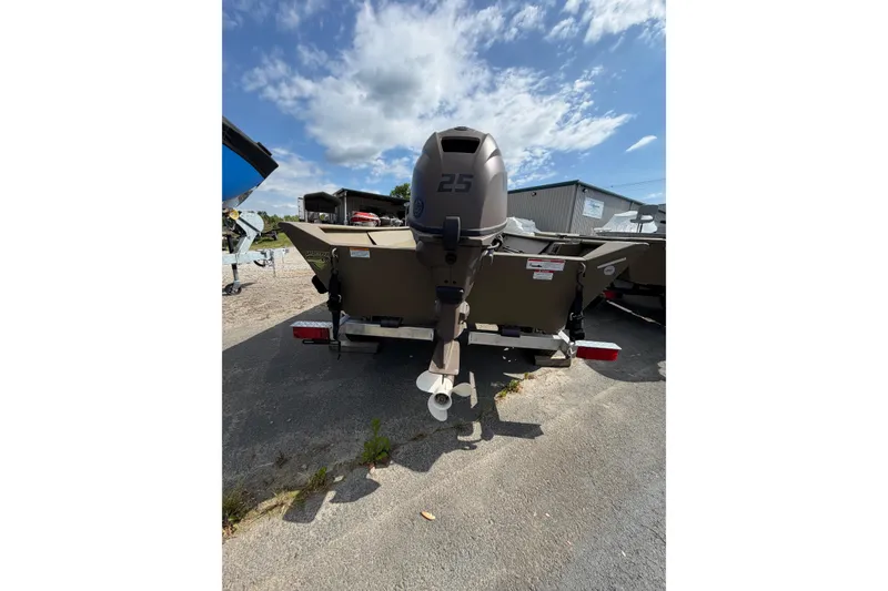 Slide: The Image of 2026 G3 Gator Tough Package Jon 15 FL boat with 25 HP motor, parked outdoors. - 3