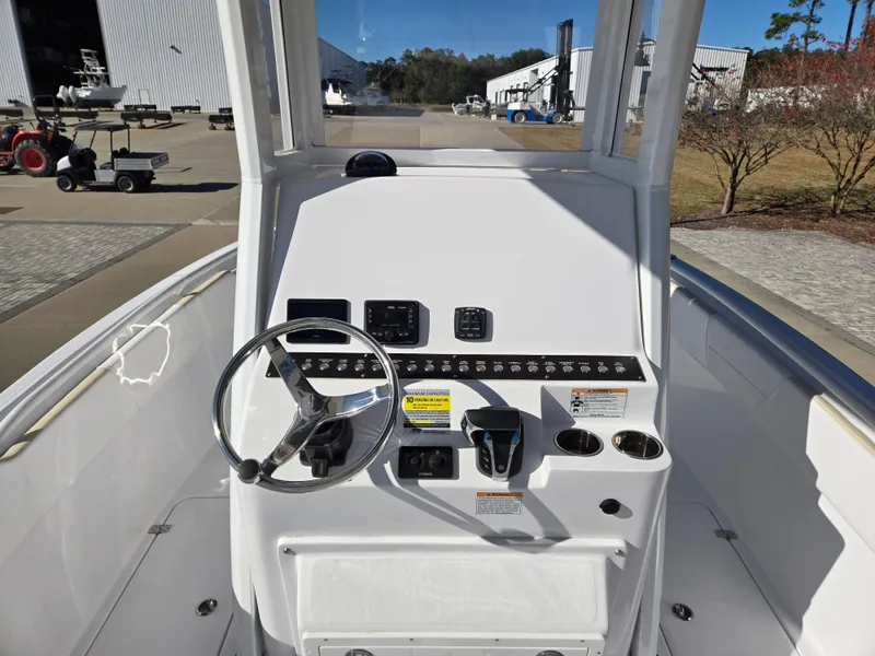 Slide: The Image of 2024 Century 2400CC boat helm console outdoors. - 6