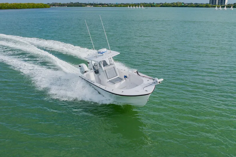 Slide: The Image of 2024 Orion 29CC boat cruising on open water, creating a dynamic wake. - 11