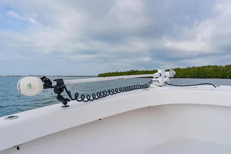 Slide: The Image of 2024 Orion 29CC boat with trolling motor on calm water, cloudy sky. - 15