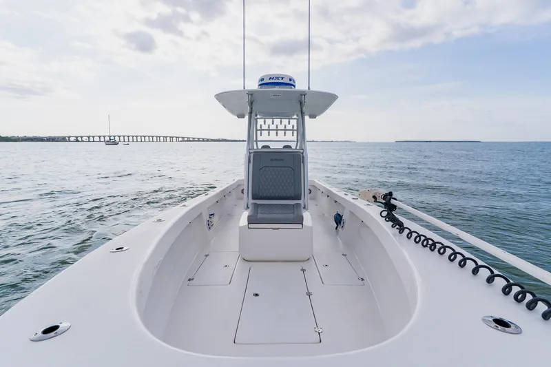 Slide: The Image of 2024 Orion 29CC boat on open water, showcasing sleek design and spacious deck. - 18