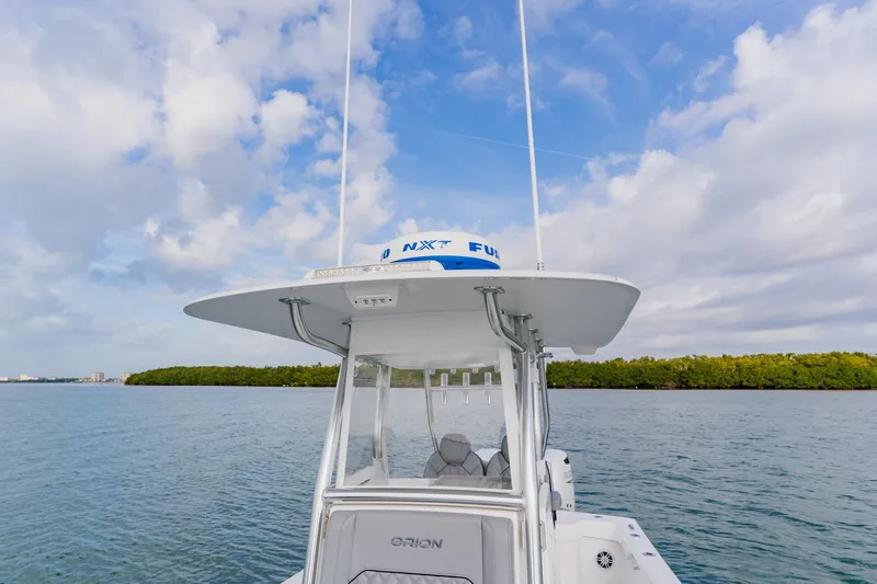 Slide: The Image of 2024 Orion 29CC boat on water under a partly cloudy sky. - 22