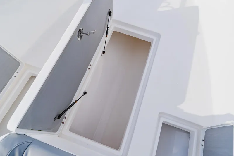 Slide: The Image of Open storage compartment on 2024 Orion 29CC boat deck. - 26