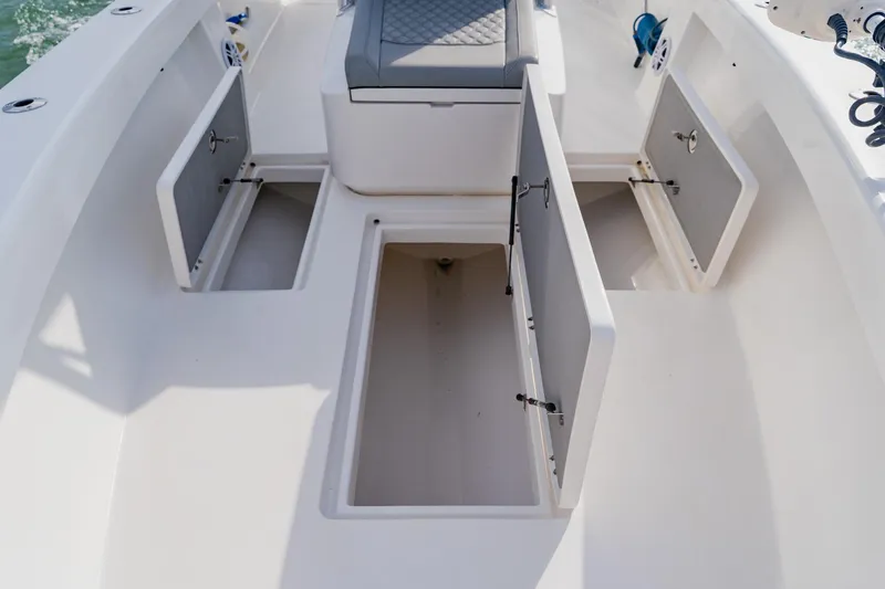 Slide: The Image of 2024 Orion 29CC boat interior with open storage compartments and seating. - 28