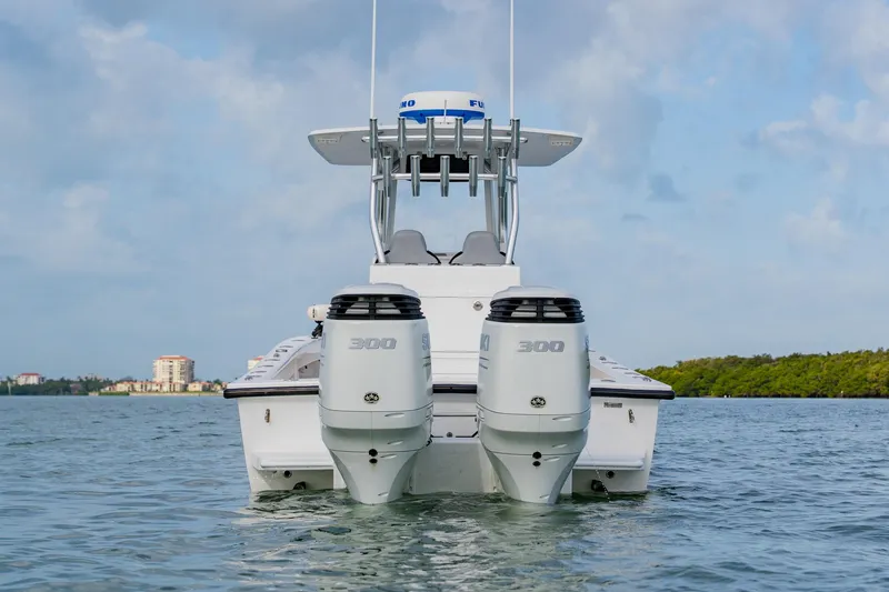 Slide: The Image of 2024 Orion 29CC boat with dual 300 horsepower engines on calm water. - 3