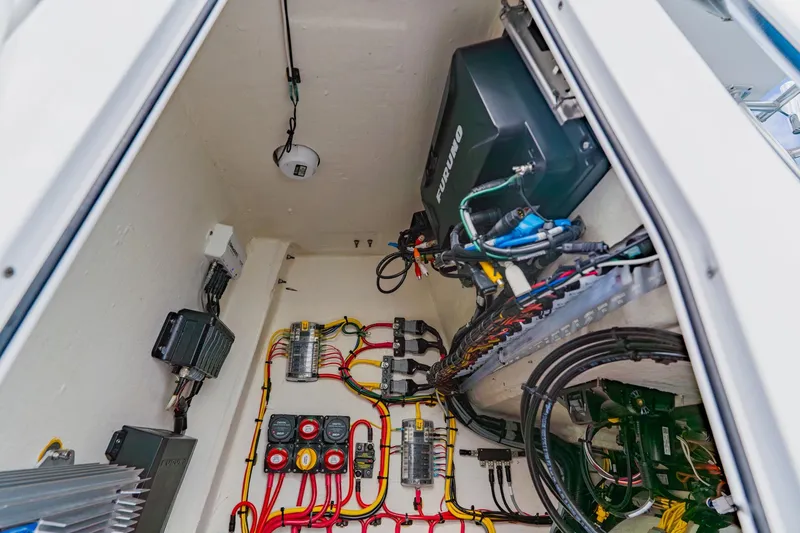 Slide: The Image of Electrical wiring and components inside a 2024 Orion 29CC boat, showcasing organized cables and equipment. - 33