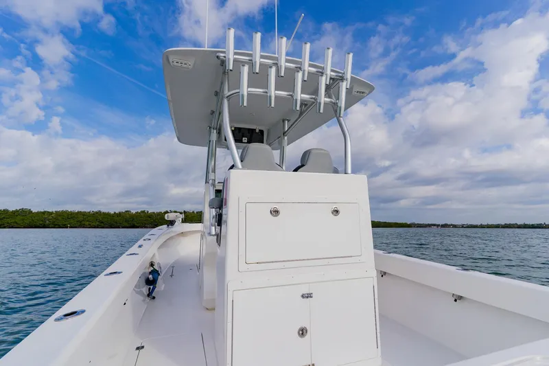 Slide: The Image of 2024 Orion 29CC boat on water, clear sky, and lush shoreline in background. - 39