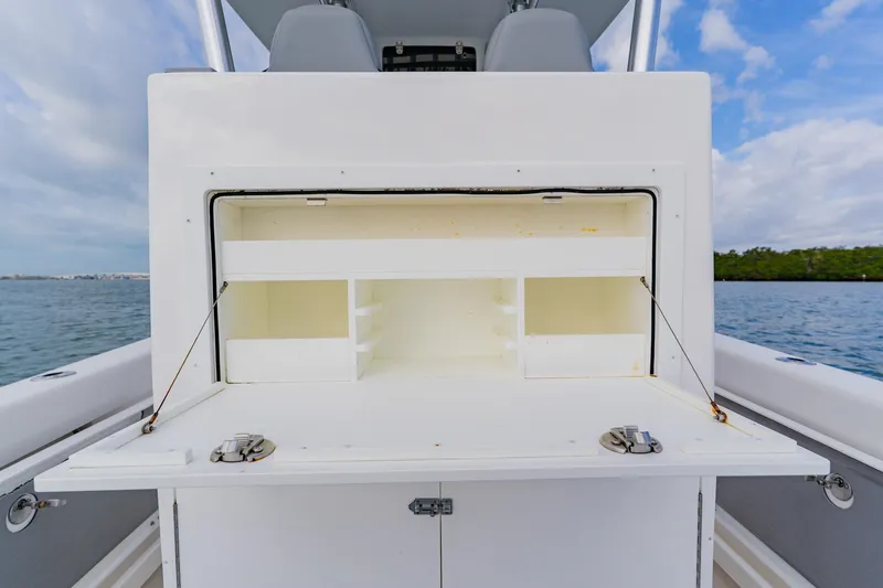 Slide: The Image of 2024 Orion 29CC boat storage compartment open on calm water. - 41