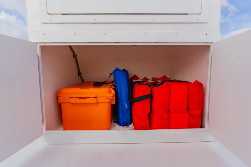 Slide: The Image of Storage compartment on 2024 Orion 29CC boat with safety gear and equipment. - 42