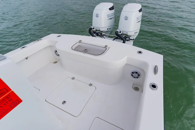 Slide: The Image of 2024 Orion 29CC boat with dual Suzuki outboard motors on water. - 43