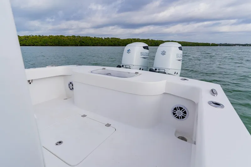 Slide: The Image of 2024 Orion 29CC boat with dual Suzuki engines on calm water. - 44