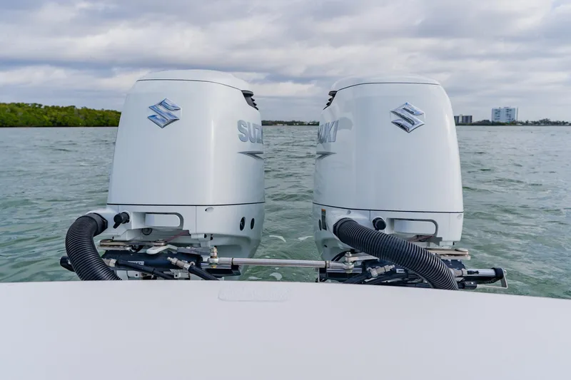 Slide: The Image of Twin Suzuki outboard motors on a 2024 Orion 29CC boat, cruising on open water. - 46