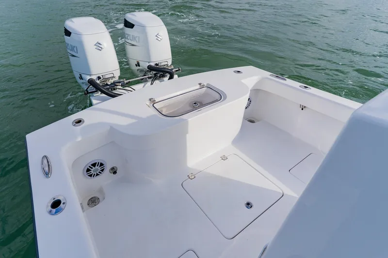 Slide: The Image of 2024 Orion 29CC boat with dual Suzuki outboard motors on calm water. - 47