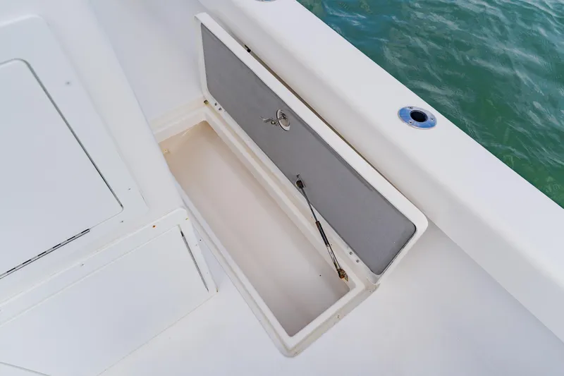 Slide: The Image of Open storage compartment on 2024 Orion 29CC boat, near water. - 50