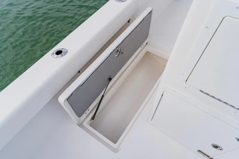 Slide: The Image of Open storage compartment on 2024 Orion 29CC boat, showcasing sleek design and functionality. - 51