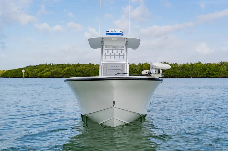 Slide: The Image of 2024 Orion 29CC boat on calm water with clear sky background. - 6