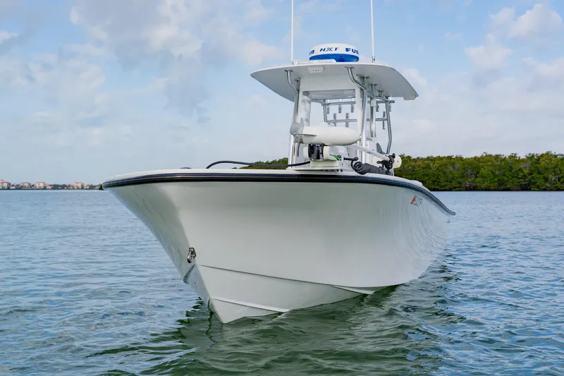 Slide: The Image of 2024 Orion 29CC boat on calm water, showcasing sleek design and modern features. - 7