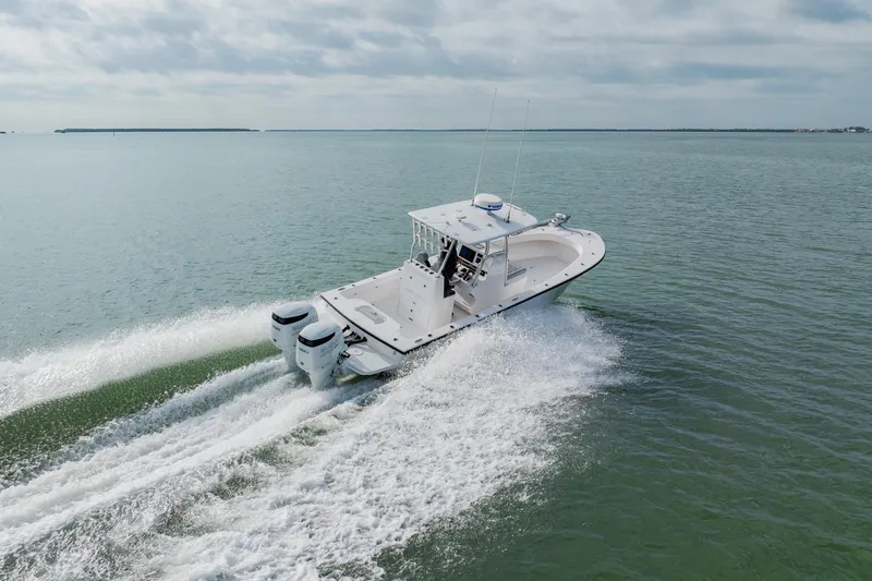 Slide: The Image of 2024 Orion 29CC boat cruising on open water, showcasing twin engines and sleek design. - 8