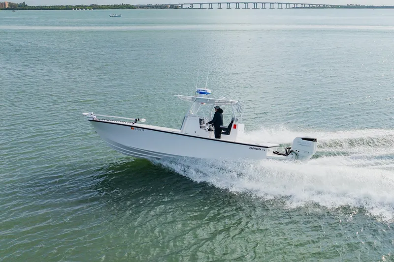 Slide: The Image of 2024 Orion 29CC boat cruising on open water, showcasing sleek design and powerful performance. - 9