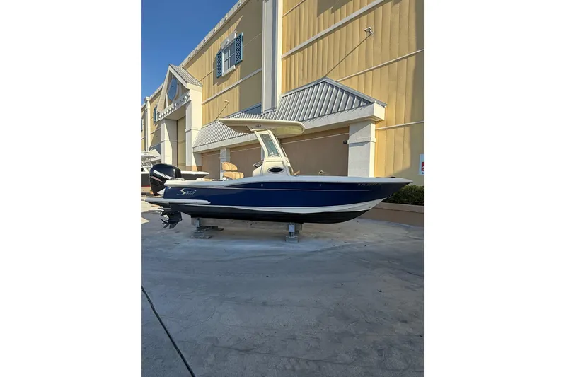 The Image of 2018 Scout 225 XSF boat displayed outdoors near a building. - 0