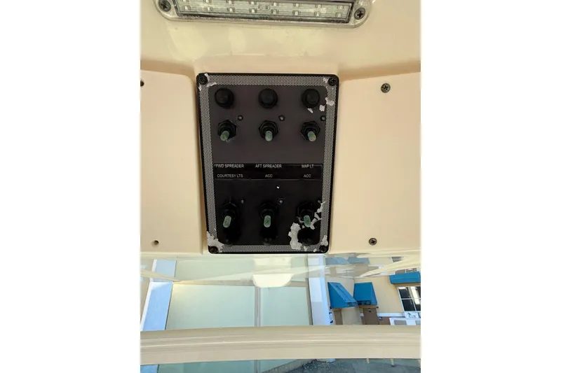 Slide: The Image of Control panel of a 2018 Scout 225 XSF boat with various switches. - 15
