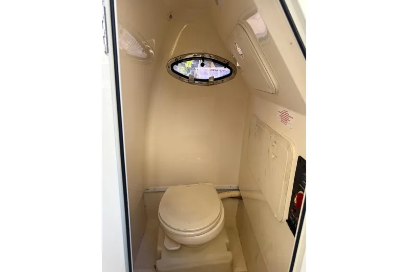 Slide: The Image of 2018 Scout 225 XSF boat interior with compact marine toilet. - 22