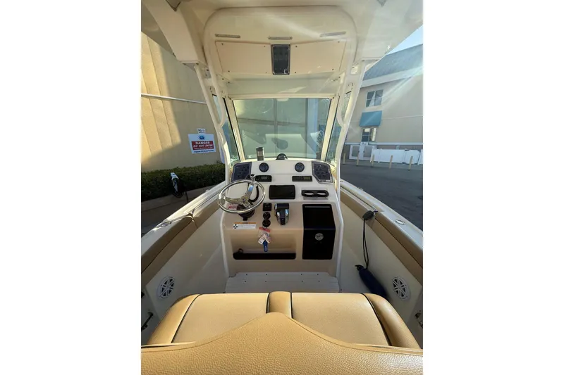 Slide: The Image of 2018 Scout 225 XSF boat interior with steering wheel and control panel. - 26