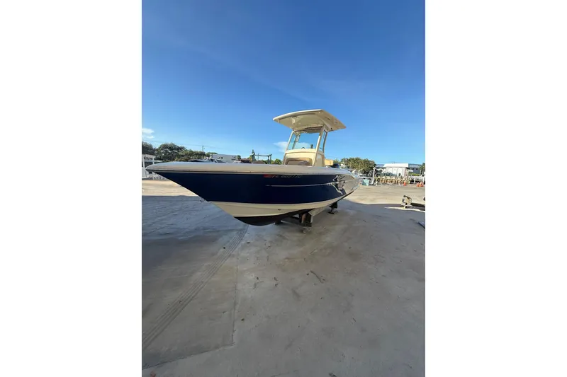 Slide: The Image of 2018 Scout 225 XSF boat on dry dock under clear blue sky. - 4