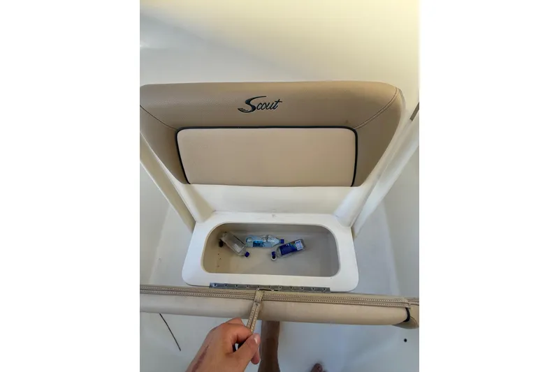 Slide: The Image of 2018 Scout 225 XSF boat seat with storage compartment, containing bottles. - 8