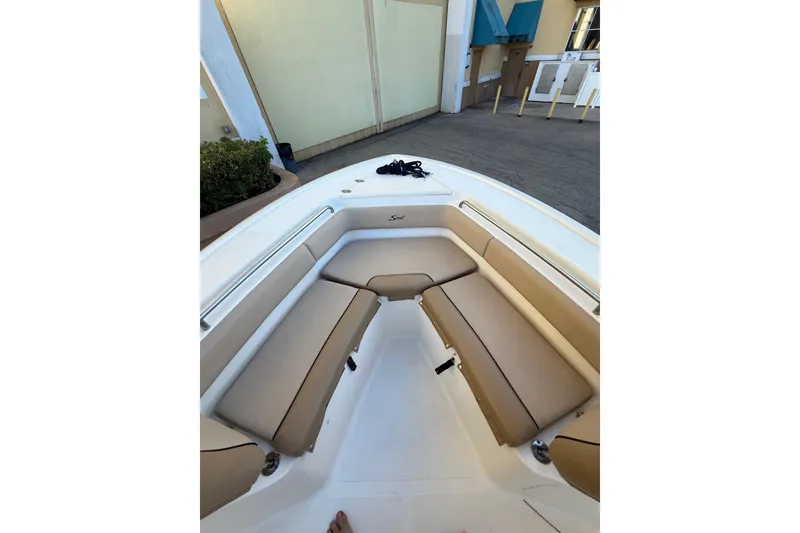 Slide: The Image of 2018 Scout 225 XSF boat interior with tan cushioned seating. - 9