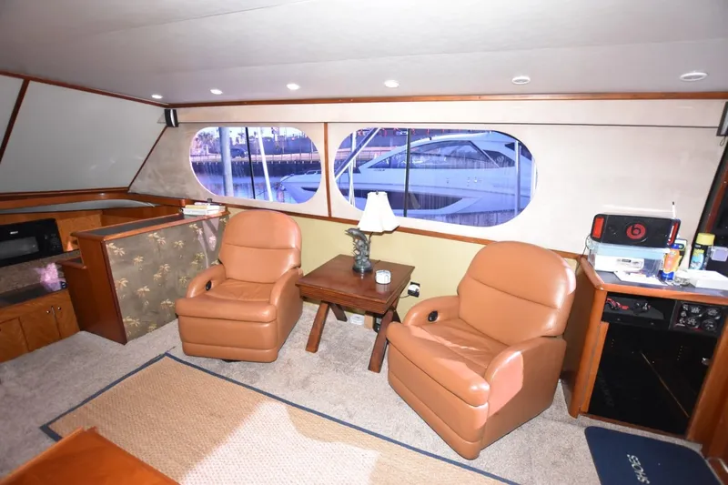 Slide: The Image of Interior of 1990 Ocean Yachts 48 Super Sport with leather chairs and large windows. - 14