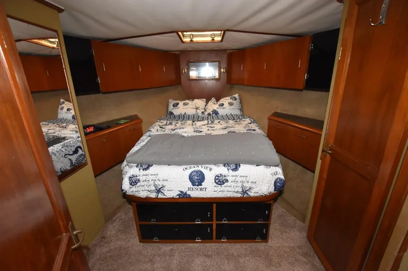 Slide: The Image of Luxurious cabin interior of 1990 Ocean Yachts 48 Super Sport with cozy bedding. - 18