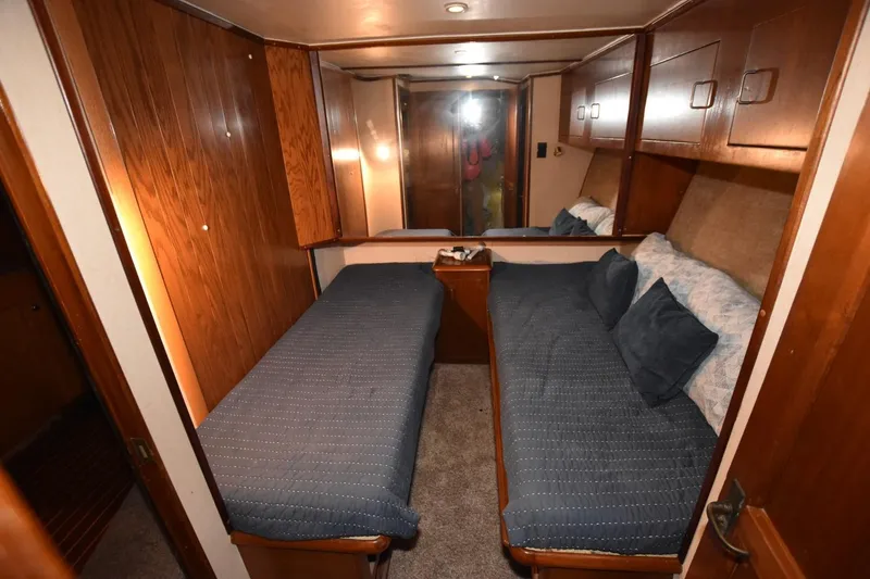 Slide: The Image of 1990 Ocean Yachts 48 Super Sport cabin with twin beds and wooden interior. - 20