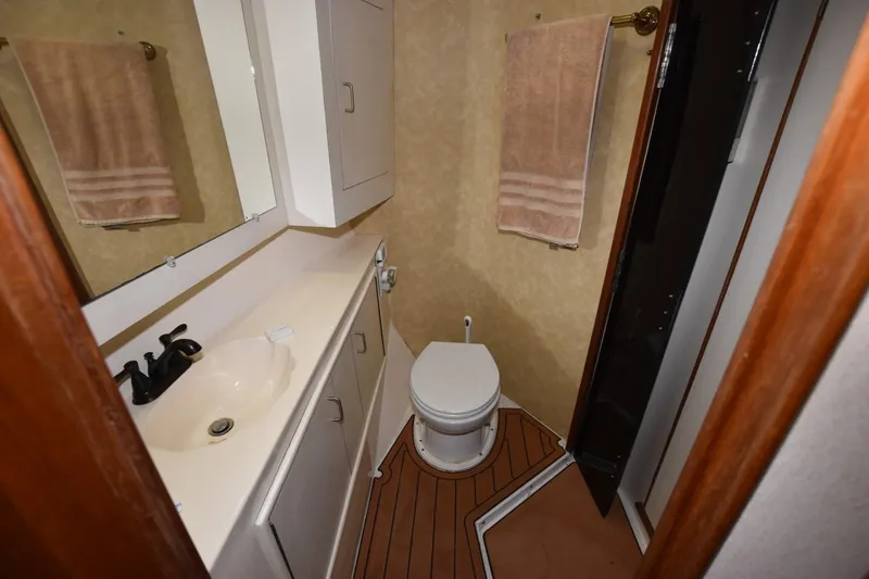 Slide: The Image of Bathroom interior of 1990 Ocean Yachts 48 Super Sport, featuring sink and toilet. - 21