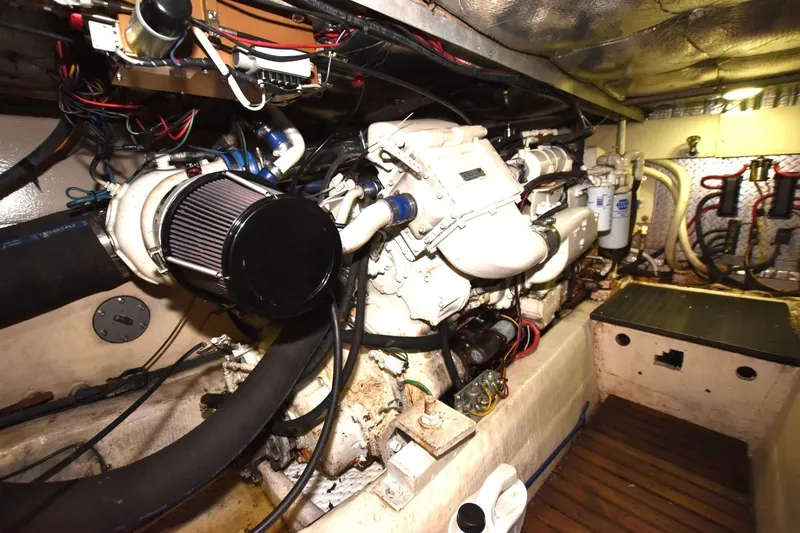 Slide: The Image of Engine room of 1990 Ocean Yachts 48 Super Sport, showcasing detailed mechanical components. - 22