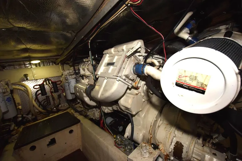 Slide: The Image of Engine room of 1990 Ocean Yachts 48 Super Sport, showcasing mechanical components and wiring. - 23