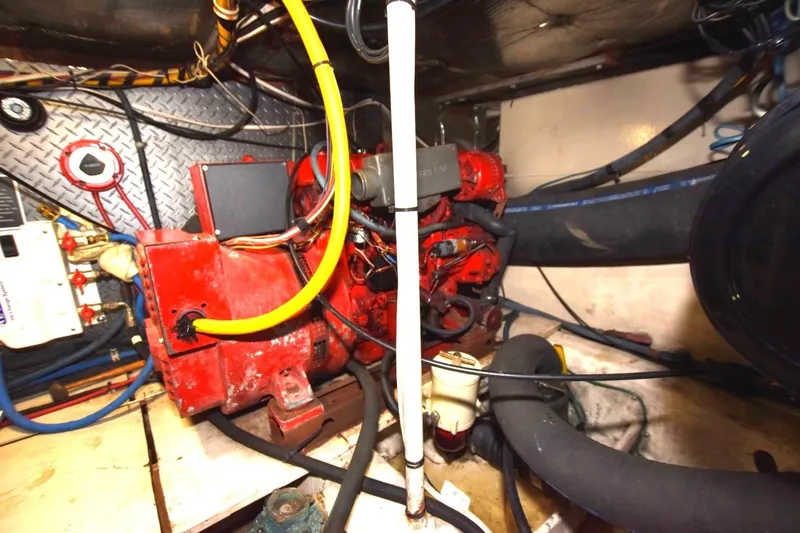 Slide: The Image of Engine room of 1990 Ocean Yachts 48 Super Sport with red machinery and wiring. - 24