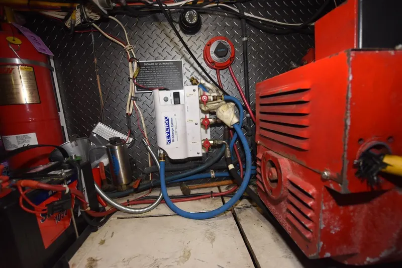 Slide: The Image of Engine room of 1990 Ocean Yachts 48 Super Sport with mechanical components and wiring. - 25
