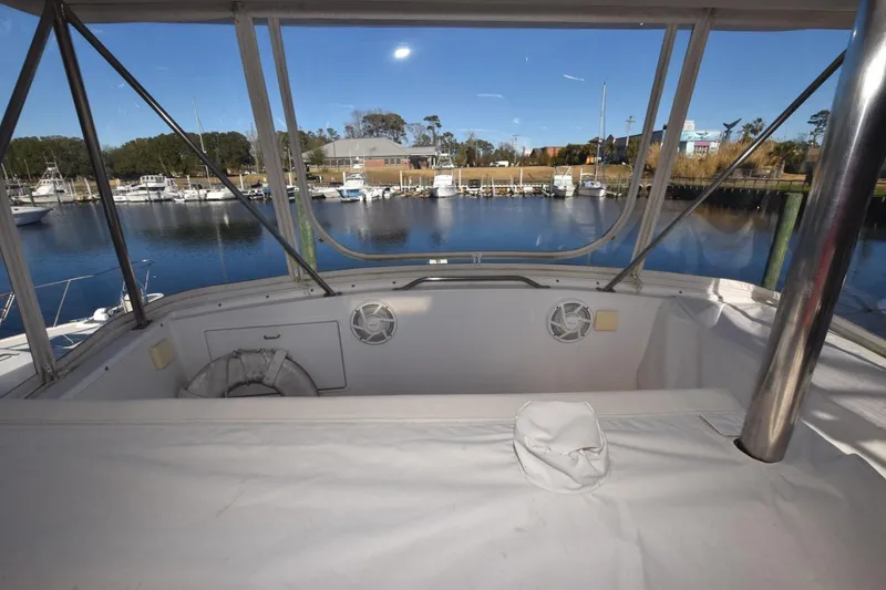 Slide: The Image of 1990 Ocean Yachts 48 Super Sport cockpit view overlooking marina with clear blue sky. - 3