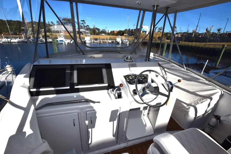 Slide: The Image of Helm of 1990 Ocean Yachts 48 Super Sport with dual screens and steering wheel. - 4