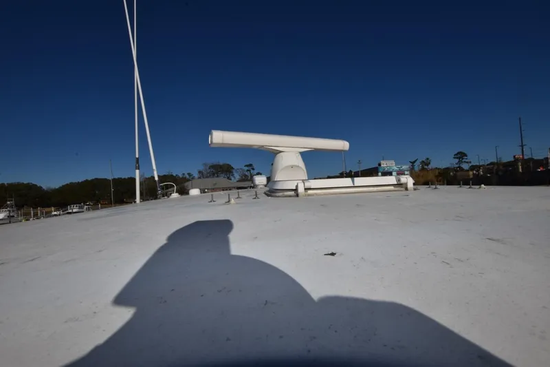 Slide: The Image of 1990 Ocean Yachts 48 Super Sport yacht deck with radar equipment under clear blue sky. - 7