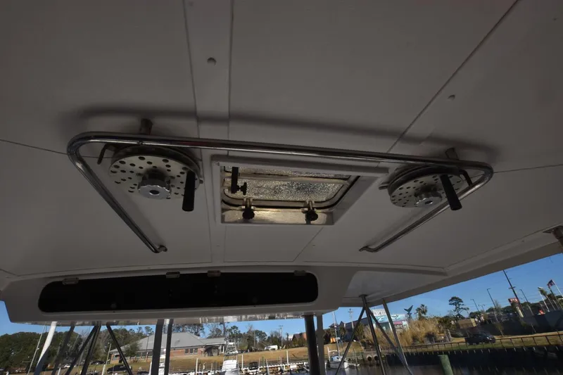 Slide: The Image of Ceiling view of 1990 Ocean Yachts 48 Super Sport with metal fixtures and hatch. - 8
