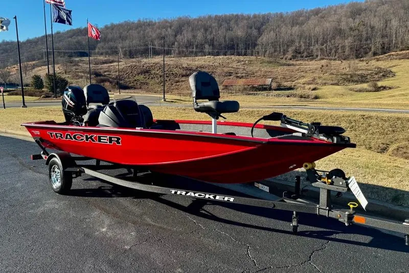 Slide: The Image of 2026 Tracker Pro Team 175 Crappie Edition boat on trailer, red color, outdoor setting. - 2